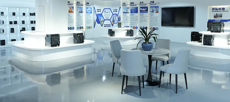 Modern showroom with electrical equipment displays, white counters, and informational posters on the wall